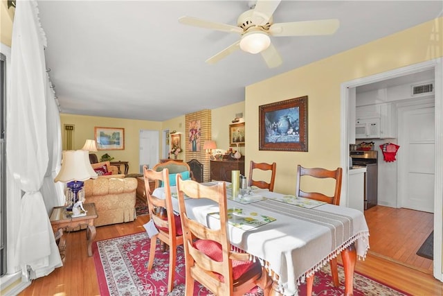 dining area featuring ceiling fan and light hardwood / wood-style flooring