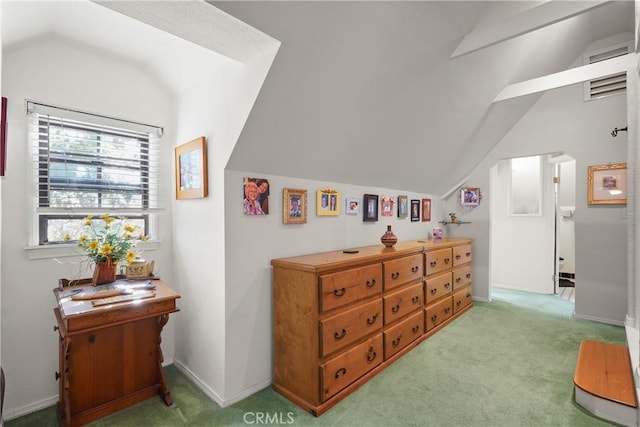 bedroom with vaulted ceiling and light colored carpet