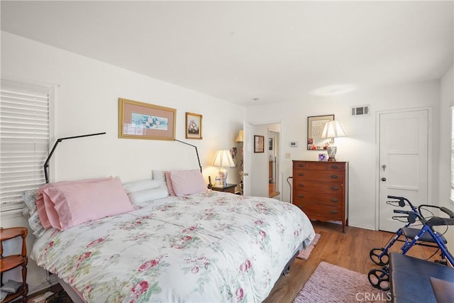 bedroom with hardwood / wood-style flooring