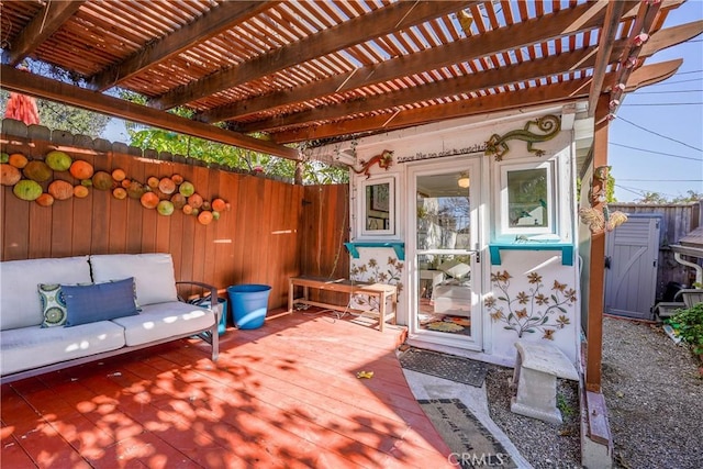 wooden terrace with an outdoor structure and a pergola