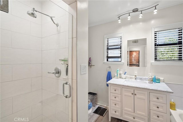 bathroom featuring vanity and a shower with shower door