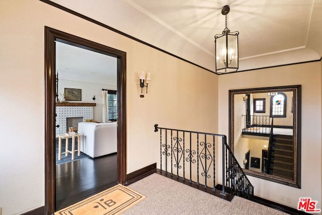 hallway featuring carpet and an inviting chandelier