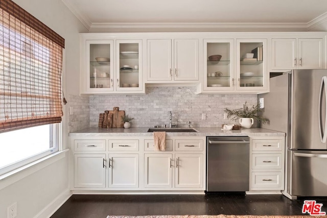 bar with appliances with stainless steel finishes, backsplash, white cabinets, and sink