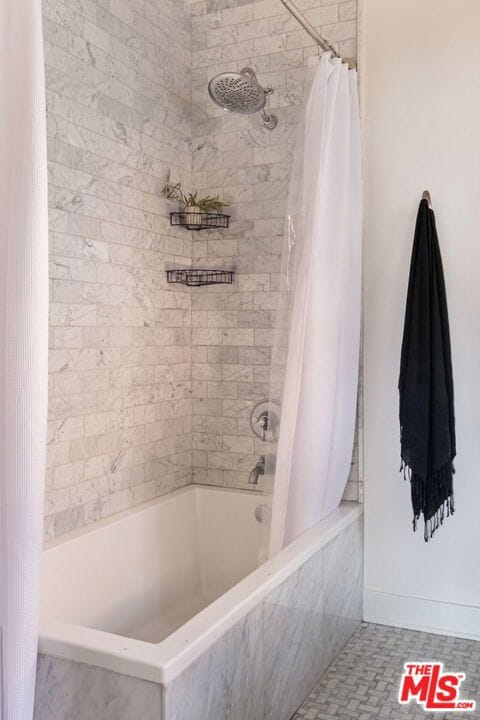 bathroom with shower / bath combination with curtain