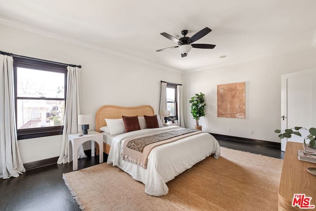 bedroom featuring ceiling fan, dark hardwood / wood-style flooring, and ornamental molding