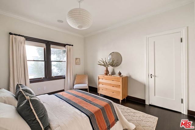 bedroom with dark hardwood / wood-style floors and ornamental molding