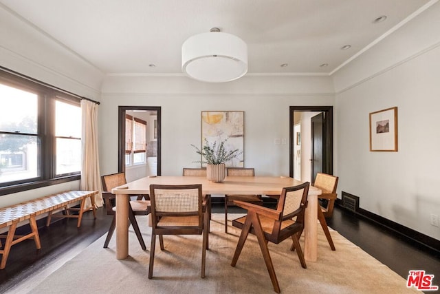 dining room with wood-type flooring and ornamental molding