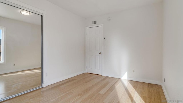 unfurnished room with light hardwood / wood-style flooring