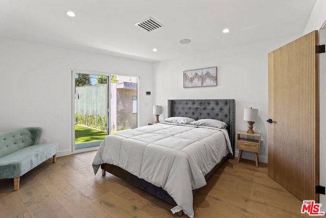 bedroom with light hardwood / wood-style floors and access to outside