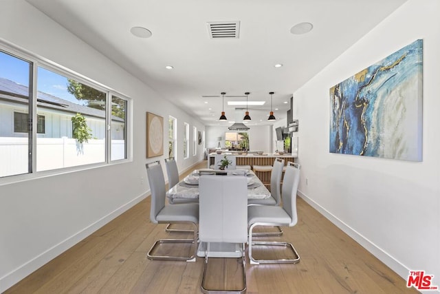 dining space featuring light wood-type flooring