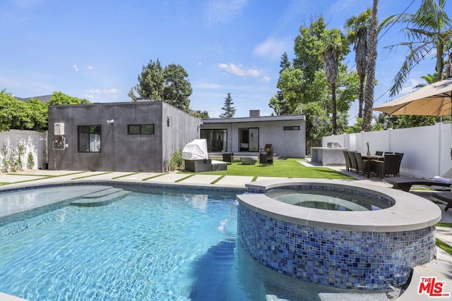 view of swimming pool featuring an in ground hot tub