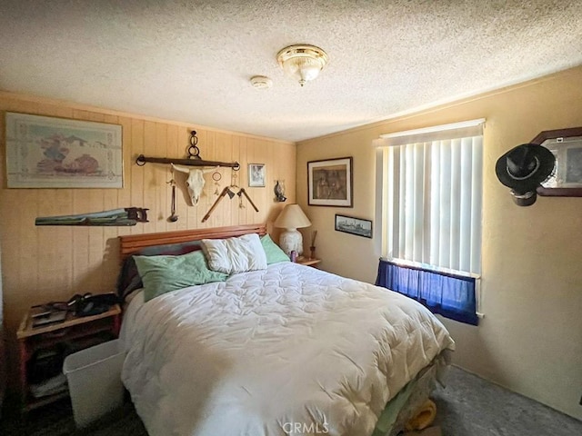 bedroom with crown molding, carpet flooring, a textured ceiling, and wood walls