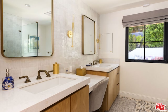 bathroom with vanity, tile patterned flooring, backsplash, and walk in shower