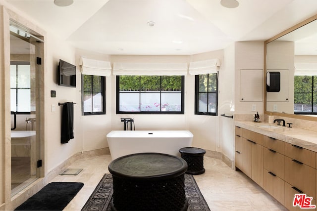 bathroom featuring a wealth of natural light, shower with separate bathtub, vanity, and tile patterned flooring