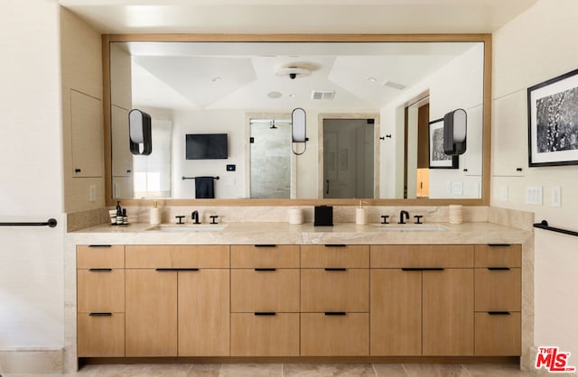 bathroom with lofted ceiling and vanity