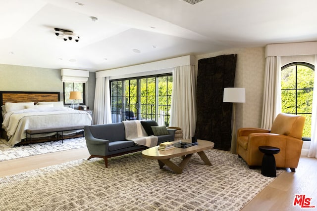 bedroom featuring multiple windows and light hardwood / wood-style flooring