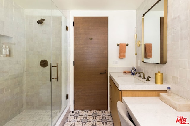 bathroom featuring walk in shower, vanity, and tile patterned floors