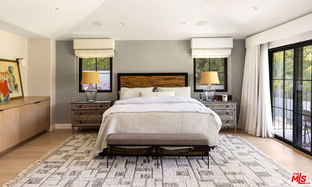 bedroom featuring access to exterior and light hardwood / wood-style floors