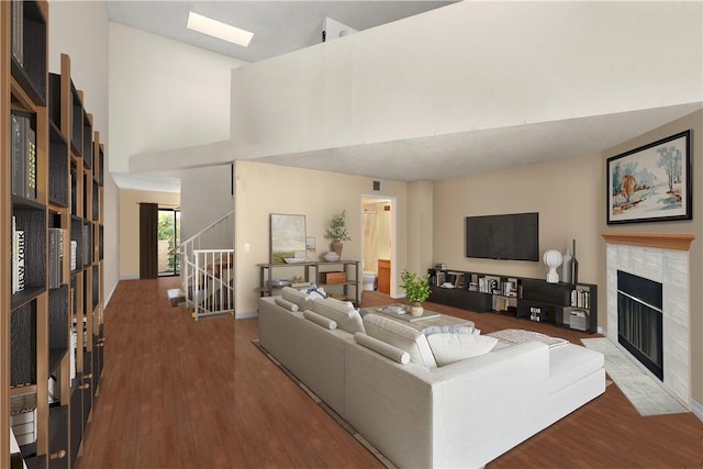 living room with high vaulted ceiling and wood-type flooring