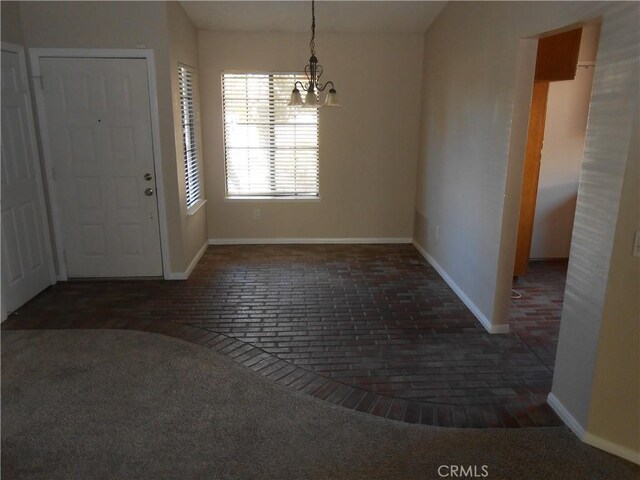 foyer entrance with a chandelier