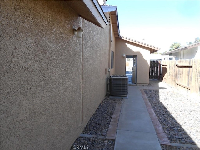 view of side of property featuring central AC