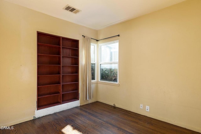 spare room featuring dark hardwood / wood-style floors