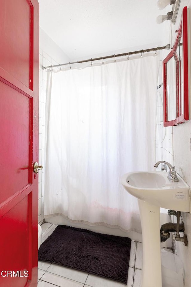 bathroom with toilet, tile patterned flooring, and shower / bathtub combination with curtain