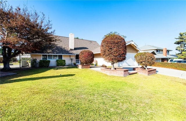 view of front facade with a garage and a front lawn