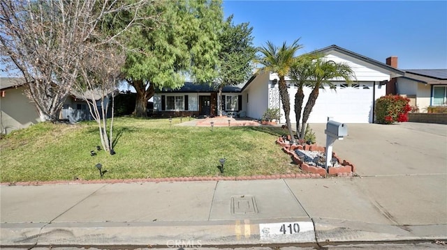 ranch-style house featuring a front yard and a garage