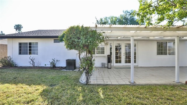 rear view of property with a pergola, a patio area, french doors, and a yard