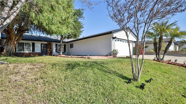 single story home featuring a front yard and a garage