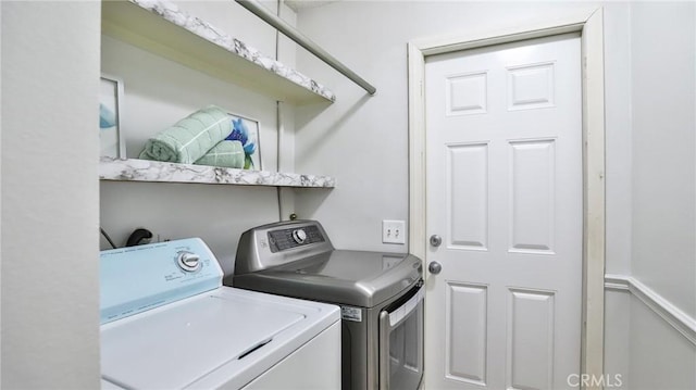 clothes washing area featuring washing machine and clothes dryer