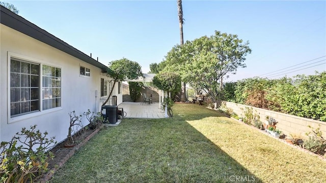 view of yard featuring central AC unit and a patio area