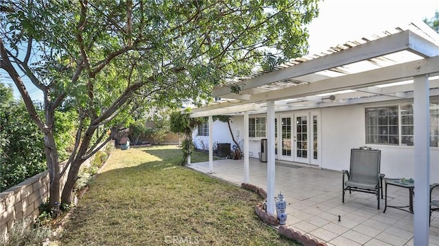 view of yard featuring a pergola, a patio area, central air condition unit, and french doors