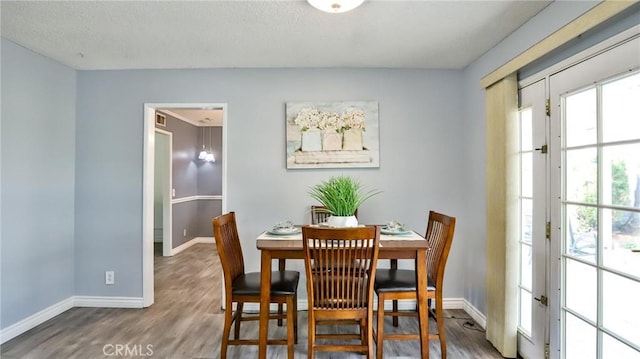 dining space with hardwood / wood-style floors