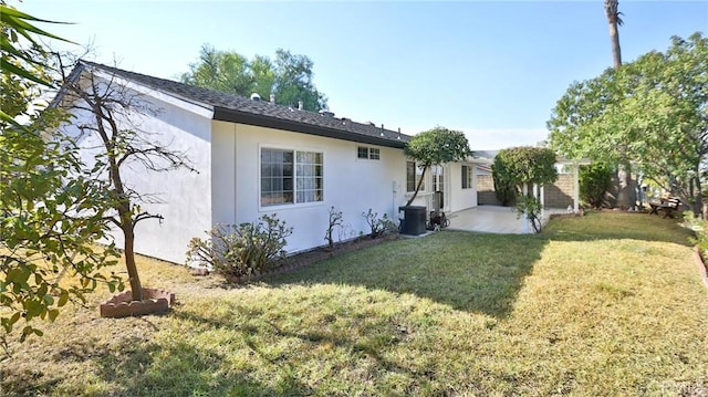 exterior space featuring central AC, a yard, and a patio