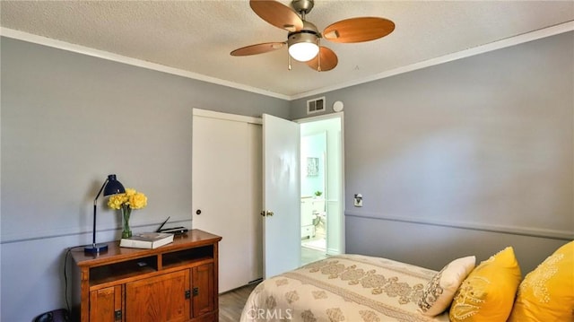 bedroom with ceiling fan, a closet, and crown molding