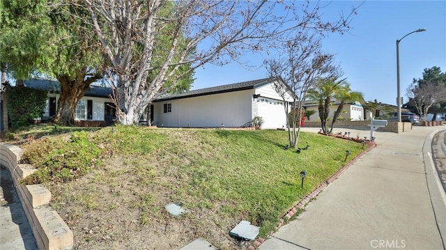 view of home's exterior with a lawn and a garage