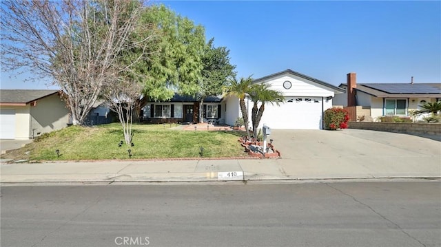 ranch-style house featuring a front yard and a garage