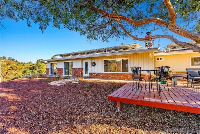 back of house with a wooden deck