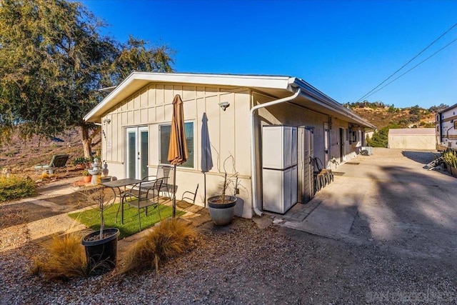 view of property exterior featuring french doors