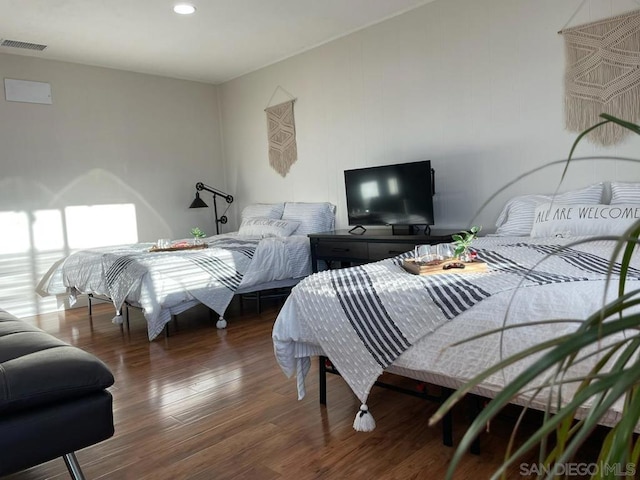 bedroom with dark hardwood / wood-style floors