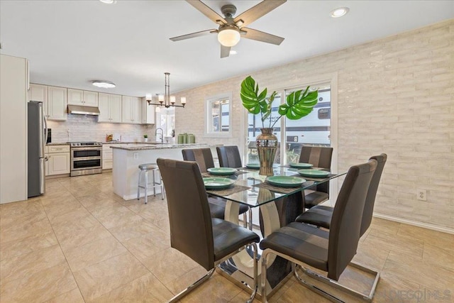 dining area with ceiling fan with notable chandelier