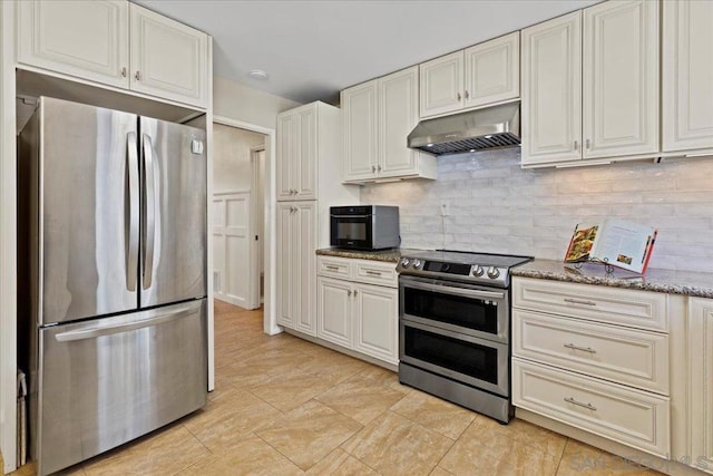 kitchen featuring white cabinets, tasteful backsplash, light stone countertops, and appliances with stainless steel finishes