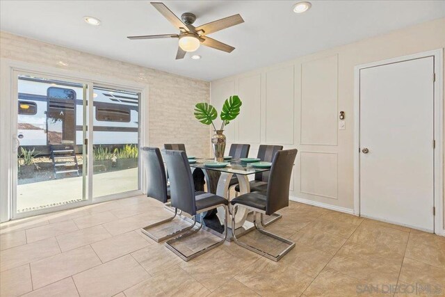 dining space with ceiling fan and light tile patterned flooring