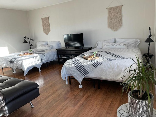 bedroom with hardwood / wood-style flooring