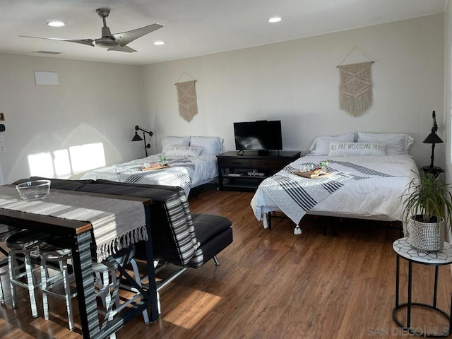 bedroom with ceiling fan and dark hardwood / wood-style flooring