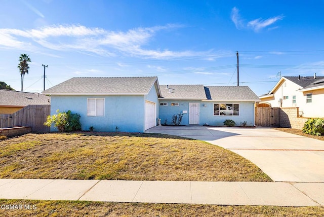 ranch-style house featuring a front lawn and a garage