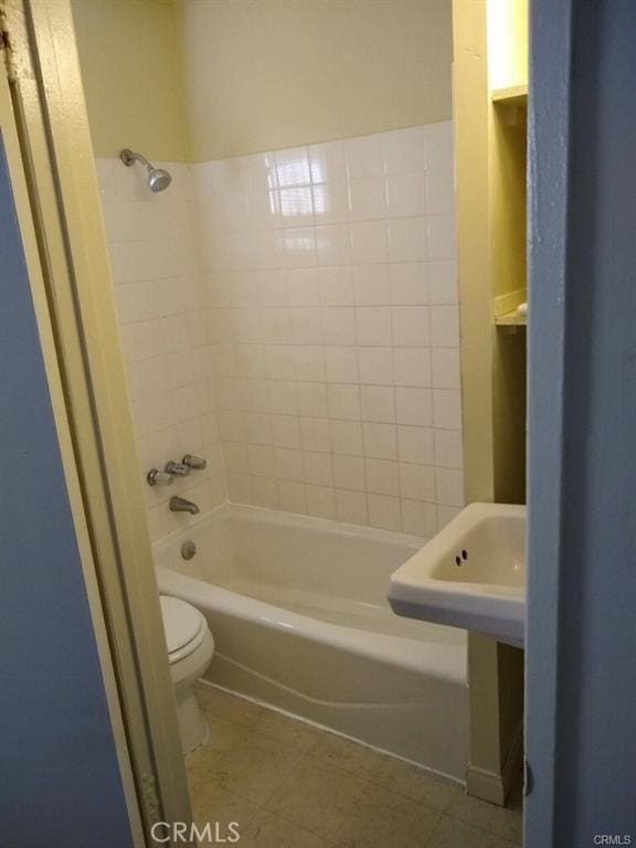 full bathroom featuring tub / shower combination, toilet, and tile patterned floors