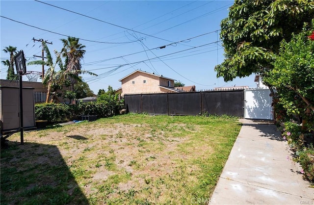 view of yard with fence and an outdoor structure